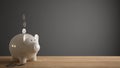 Wooden table top or shelf with white piggy bank with coins, saving money for future investments, concept idea with dark gray Royalty Free Stock Photo