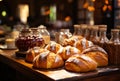 A wooden table topped with lots of bread. A delicious assortment of freshly baked bread on a rustic wooden table