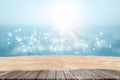 Wooden table with Tropical beautiful seascape view of sand beach and blurred blue sky with bokeh sunlight. Royalty Free Stock Photo