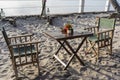 Wooden table and two chairs near sea on the tropical beach during sunset. The concept of a romantic dinner Royalty Free Stock Photo