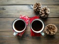 On the wooden table are two cups of Americano and three cones. winter coziness. Royalty Free Stock Photo