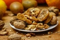 Dried fig and whole and cracked walnuts on white ceramic plate Royalty Free Stock Photo