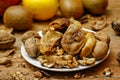 Dried fig and whole and cracked walnuts on white ceramic plate Royalty Free Stock Photo