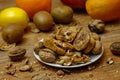 Dried fig and whole and cracked walnuts on white ceramic plate Royalty Free Stock Photo