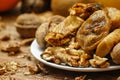 Dried fig and whole and cracked walnuts on white ceramic plate Royalty Free Stock Photo