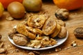 Dried fig and whole and cracked walnuts on white ceramic plate Royalty Free Stock Photo