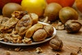 Dried fig and whole and cracked walnuts on white ceramic plate Royalty Free Stock Photo