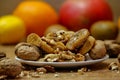 Dried fig and whole and cracked walnuts on white ceramic plate Royalty Free Stock Photo