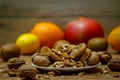 Dried fig and whole and cracked walnuts on white ceramic plate Royalty Free Stock Photo