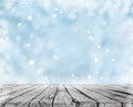 A wooden table and winter snow background with snowflakes Royalty Free Stock Photo