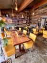 Wooden tables, chairs, table clothes in interrior of small sea food restaurant on a oyster farm