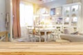 Wooden tables, wooden shelves in the foreground. Defocused image of shop or cafe with bokeh coloful lights Royalty Free Stock Photo