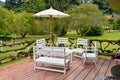 Wooden tables, white chairs in the garden