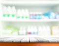 Wooden tabletop with blurred pharmacy or medicine shelf Royalty Free Stock Photo