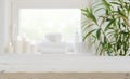 Wooden tabletop with copy space over blurred spa window background