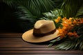 Wooden tabletop escape, large hat with tropical leaves, holiday concept Royalty Free Stock Photo