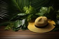 Wooden tabletop escape, large hat with tropical leaves, holiday concept Royalty Free Stock Photo