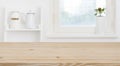 Wooden tabletop in front of blurred kitchen window, shelves background Royalty Free Stock Photo