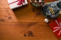 Wooden tabletop with gift boxes, small Christmas tree, vintage alarm clock and copy space Royalty Free Stock Photo