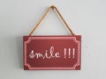 Wooden tag painted inscription: smile