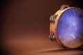 Wooden Tambourine on Brown Background