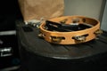 Wooden tambourine in a recording studio with gold cymbals monkey