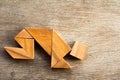 Wooden tangram puzzel in man crouch shape Royalty Free Stock Photo