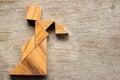 Wooden tangram puzzle in woman held the lattern shape