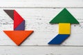 Wooden tangram in two arrow shapes one is up and the other is down Royalty Free Stock Photo