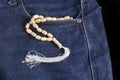 Wooden tasbih at jeans pocket