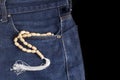 Wooden tasbih at jeans pocket