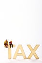 Wooden tax sign with a miniature figure couple