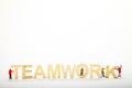 Wooden teamwork sign with miniature figure workmen