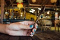 Wooden teaspoon in a womans hand. Wooden spoon in hand girl with a blue manicure Royalty Free Stock Photo