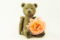 Wooden teddy bear with a rose