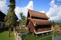 Wooden temple architecture in Lanna style on pond