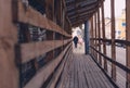 Wooden temporary structure for passage of pedestrians along street sidewalk Royalty Free Stock Photo