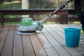 Wooden terrace floor restoration. Cleaning dust after sanding.