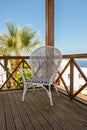 Wooden terrace of holiday villa or hotel with vintage chair and sea view Royalty Free Stock Photo