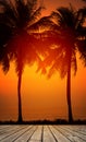 Wooden terrace over tropical island beach with coconut palm at sunset or sunrise time Royalty Free Stock Photo