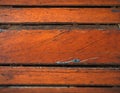 Aged orange wooden planks with peeling paint - vintage atmosphere.