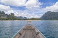 The Wooden Thai traditional long-tail boat on a lake with mountains at Ratchaprapha Dam or Khao Sok National Park, Surat Thani Royalty Free Stock Photo