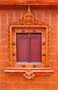 Wooden Thai window on brown tile wall