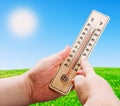 Wooden thermometer in hand Royalty Free Stock Photo