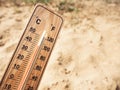 Wooden thermometer showing high temperatures over 36 degrees Celsius on sunny day Royalty Free Stock Photo