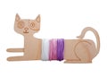 A wooden thread bobbin in the shape of a reclining cat.