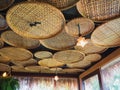 Wooden threshing baskets on ceiling and light lamp.