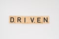 Wooden tile spelling the word driven isolated on a white background Royalty Free Stock Photo