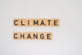 Wooden tile spelling the words climated change isolated on a white background