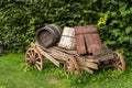 Wooden tip cart with broken barrels stands on green lawn Royalty Free Stock Photo